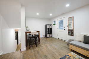 Dining space with wood finished floors and recessed lighting