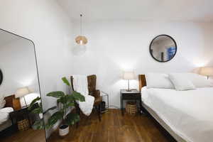Bedroom with dark wood-style flooring