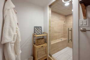 Full bathroom with a stall shower and light tile patterned floors