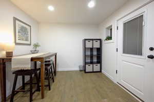 Dining room with wood finished floors and recessed lighting