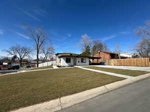 View of front of home featuring concrete driveway and an attached carport
