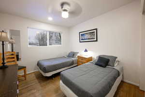 Bedroom with hardwood / wood-style floors and ceiling fan