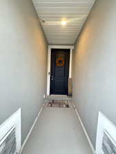 Entrance to property featuring stucco siding