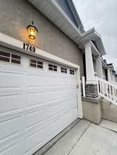 View of side of home featuring driveway and stucco siding