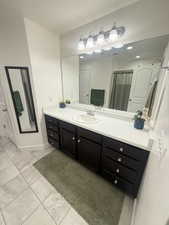 Bathroom featuring a textured ceiling, tile patterned floors, and vanity