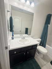 Full bathroom with vanity, shower / bathtub combination with curtain, toilet, tile patterned floors, and visible vents