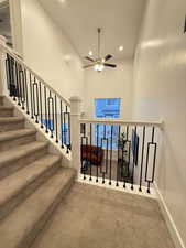 Stairway with a ceiling fan, carpet floors, baseboards, and recessed lighting