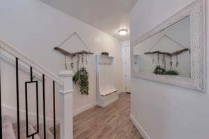 Corridor featuring wood finished floors and baseboards