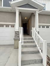 Doorway to property featuring stucco siding and stone siding