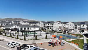 View of community featuring uncovered parking, a mountain view, and a residential view