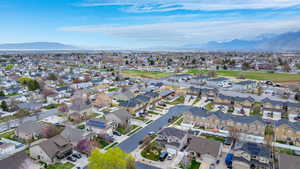 Birds eye view of property with a mountain view and a residential view