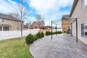 View of yard featuring a fenced backyard, cooling unit, a patio area, and an outdoor structure