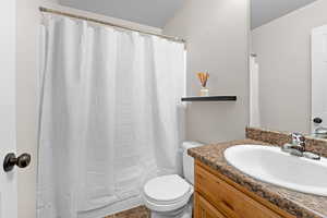 Full bathroom featuring toilet and vanity