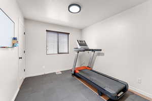 Workout room featuring baseboards and tile patterned floors