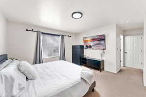 Carpeted bedroom featuring baseboards