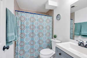 Full remodeled bathroom in the basement, featuring a shower with tile walls and vanity