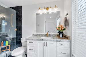 Bathroom with timeless shaker vanity and granite countertop.
