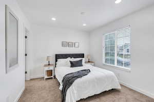 Master bedroom featuring a large window, carpet and recessed lighting