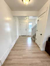 Interior space with visible vents, light wood-style floors, stairway, and a textured ceiling