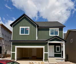 Craftsman house featuring driveway, board and batten siding, a shingled roof, and an attached garage