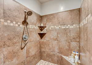 Full bath with a tile shower