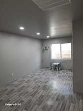 Unfurnished room featuring visible vents, wood finished floors, and recessed lighting