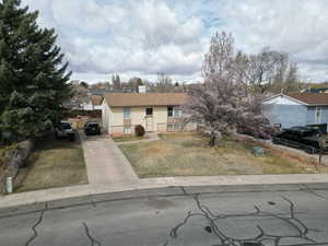 View of front facade featuring driveway, and front lawn