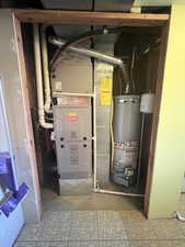 Utility room with gas water heater. Both replace sometime since 2021