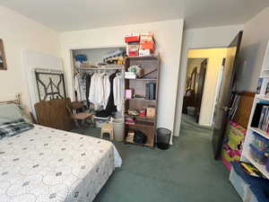 Bedroom with a closet and carpet flooring