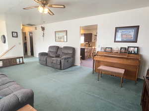 Living area with a ceiling fan, and carpet