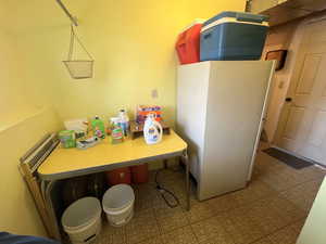 laundry area with freestanding freezer