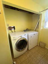 Laundry area featuring baseboards, washer and dryer, and laundry area