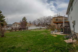 View of yard featuring a fenced backyard, stairway, and a wooden deck
