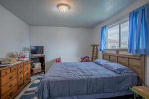 Bedroom with a textured ceiling