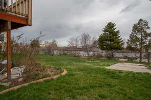 View of yard with a fenced backyard and a patio area