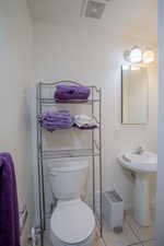 Bathroom featuring baseboards, visible vents, toilet, and tile patterned flooring