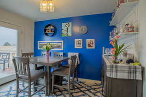 Dining room with baseboards and a textured ceiling