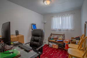 Home office with baseboards and a textured ceiling