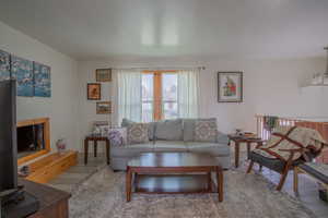 Living area with a textured ceiling and wood finished floors