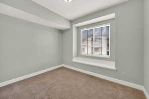 Carpeted empty room with baseboards