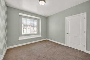 Unfurnished room featuring carpet flooring and baseboards