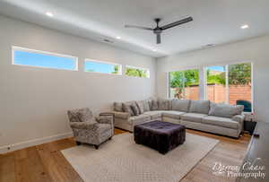 Living area featuring visible vents, a ceiling fan, and plenty of natural light