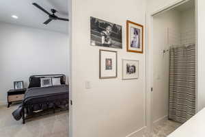Bedroom featuring light colored carpet and a ceiling fan