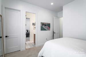 Bedroom with baseboards, recessed lighting, and light colored carpet