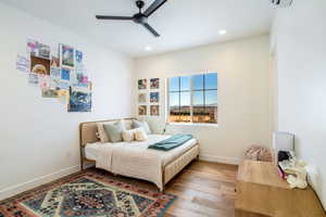 Bedroom featuring wood finished floors, a ceiling fan, and recessed lighting