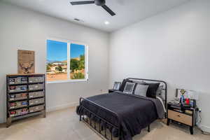 Bedroom featuring light carpet, a ceiling fan, and recessed lighting