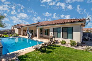 Rear view of house featuring a fenced backyard, a patio, and stucco siding
