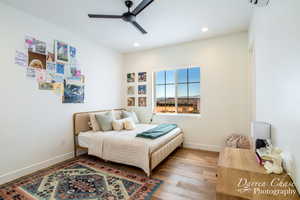 Bedroom with baseboards, ceiling fan, wood finished floors, and recessed lighting