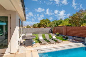 Swimming pool featuring a patio, a fenced backyard, and grilling area