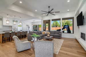 Living area featuring a fireplace, light wood-style floors, and plenty of natural light